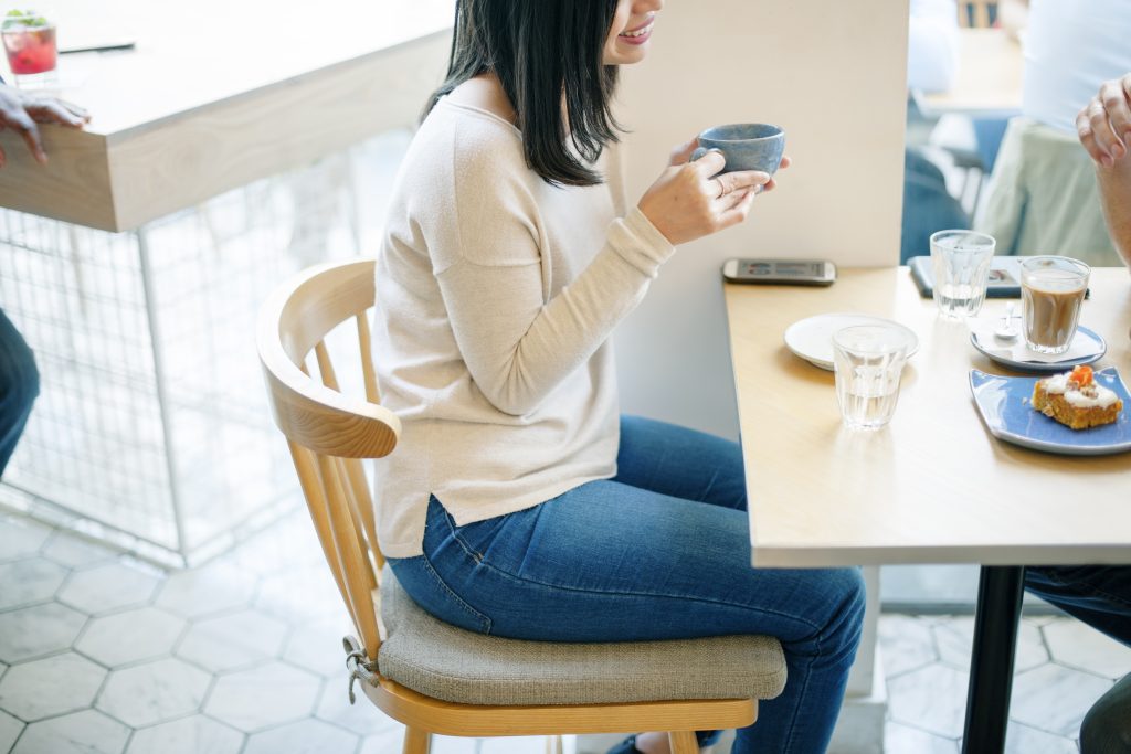 Asian woman drinking coffee with friend free image